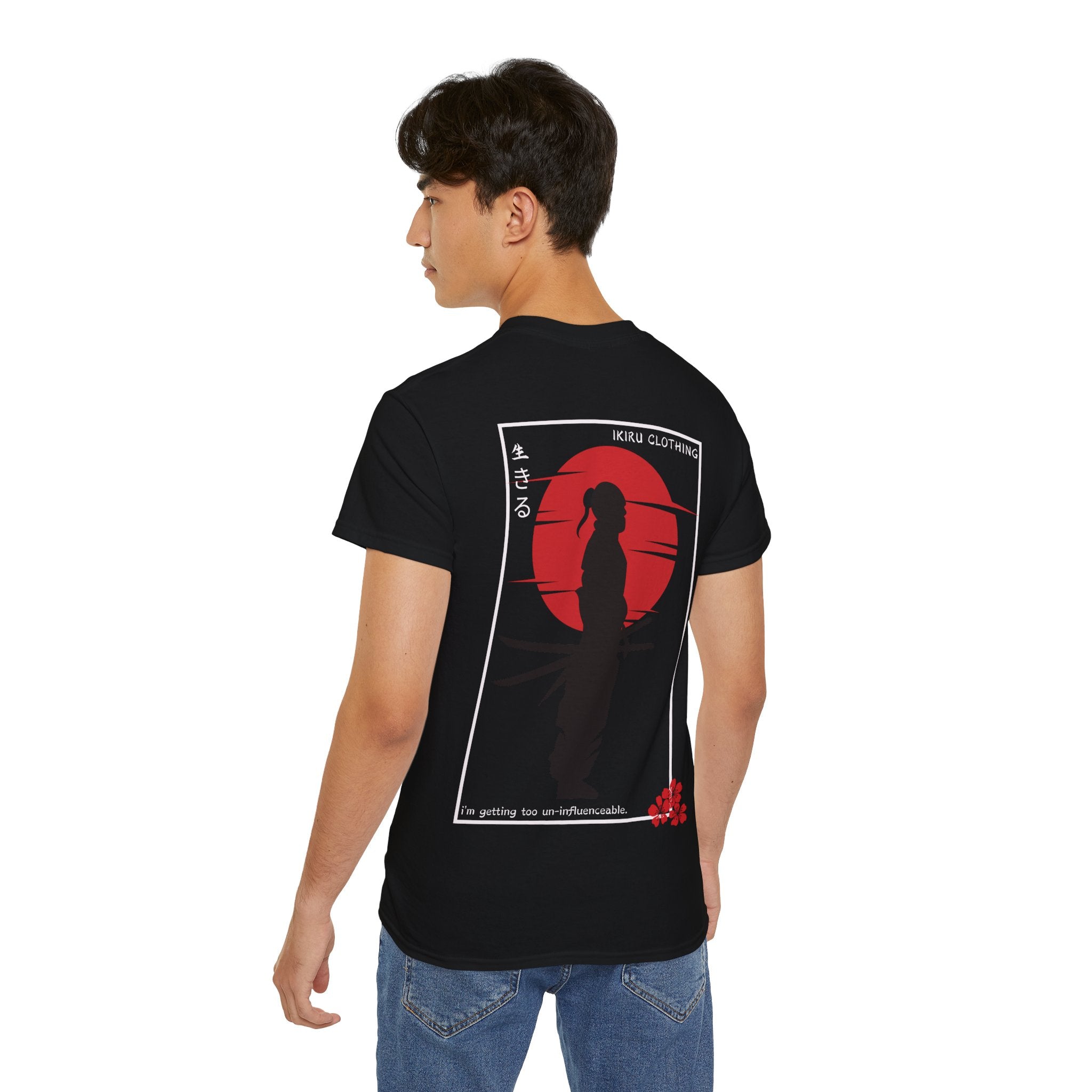 Person wearing a black t-shirt with a Japenese samurai and sun on the back from 'IKIRU CLOTHING' on a white background