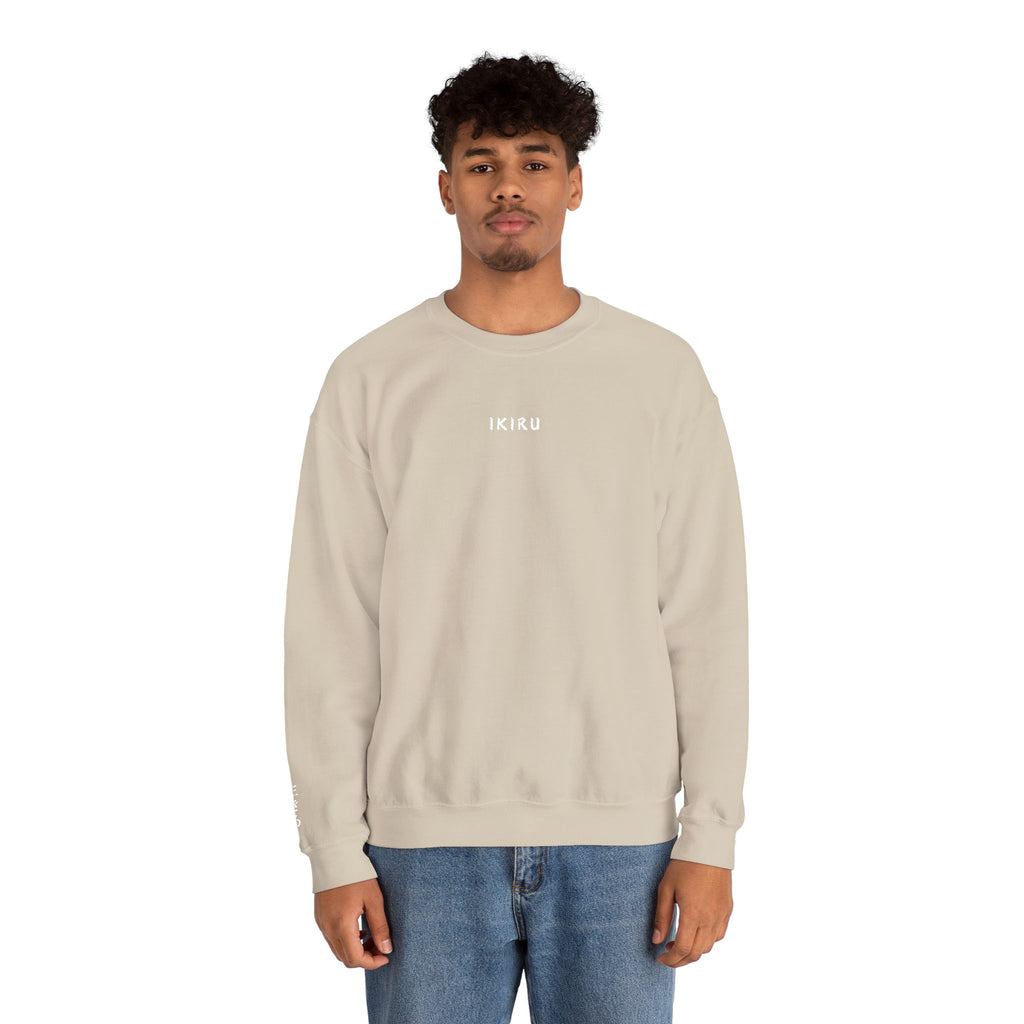Man wearing a beige sweatshirt with an IKIRU logo on a white background