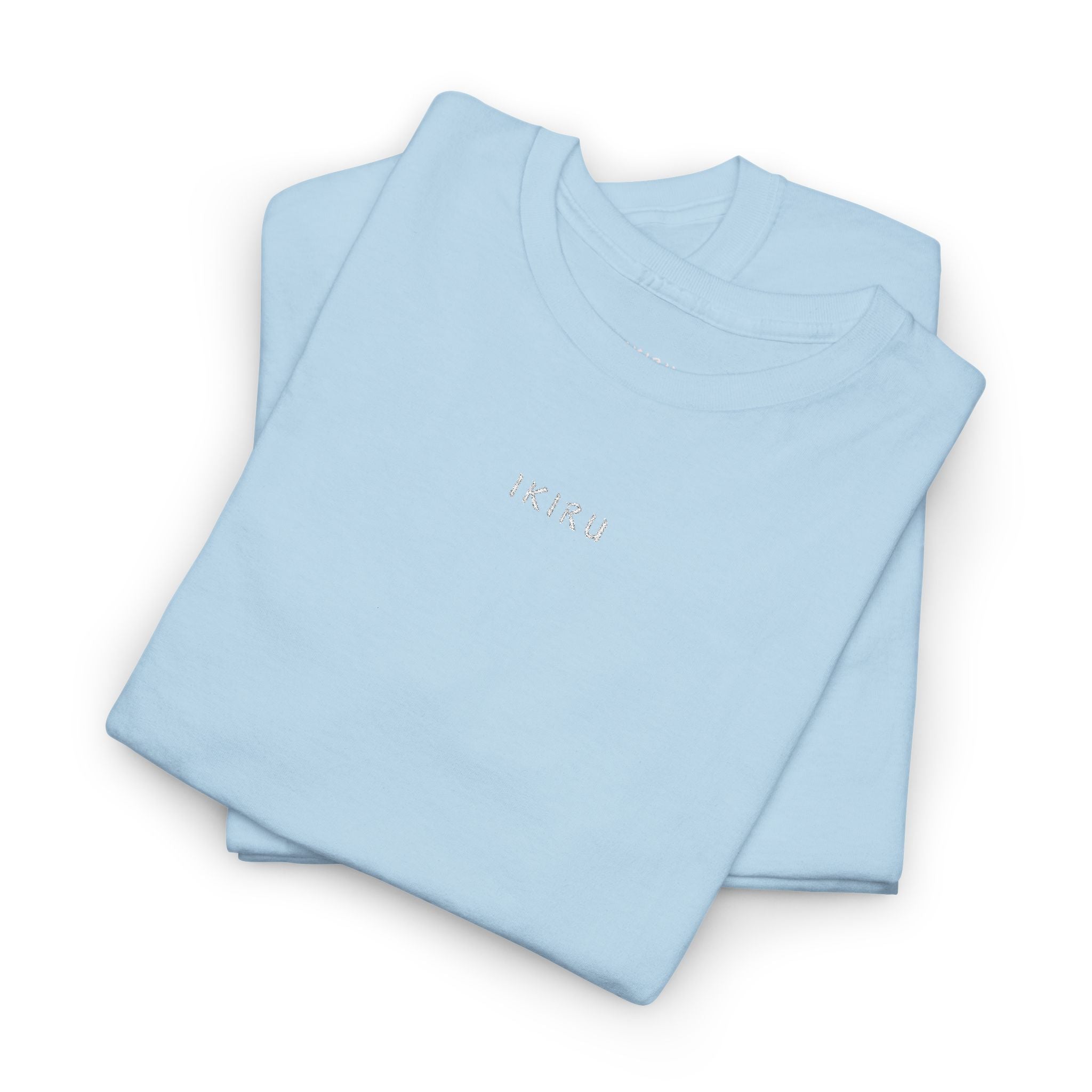 Folded light blue shirt with IKIRU logo on a white background