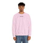 Person wearing a light pink sweatshirt with a small ikiru logo on a white background