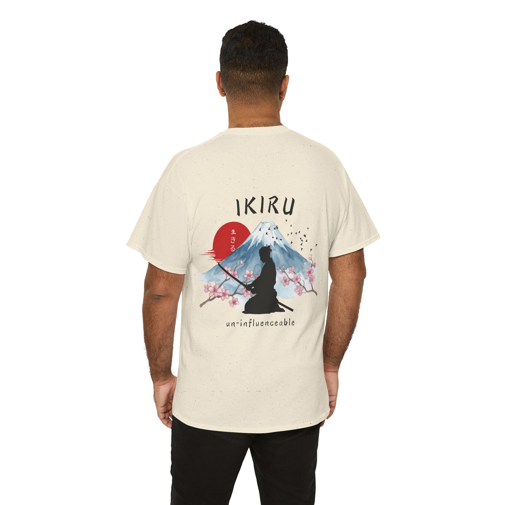 Person wearing a beige t-shirt with Japanese mountain, samurai, blossom and IKIRU on the back on a white background