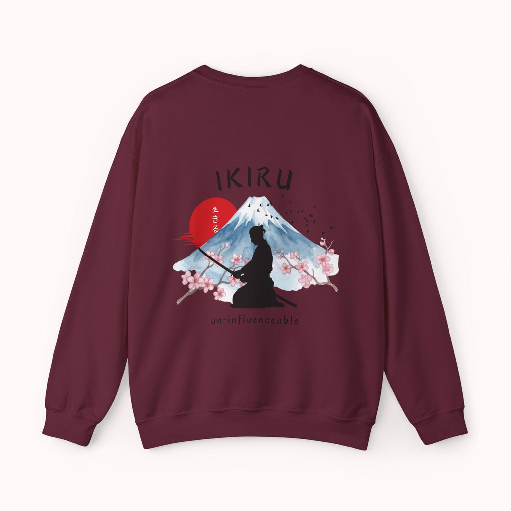 Maroon sweater with a mountain, samurai, and blossom tree design on the back saying 'un-influenceable' against a white background