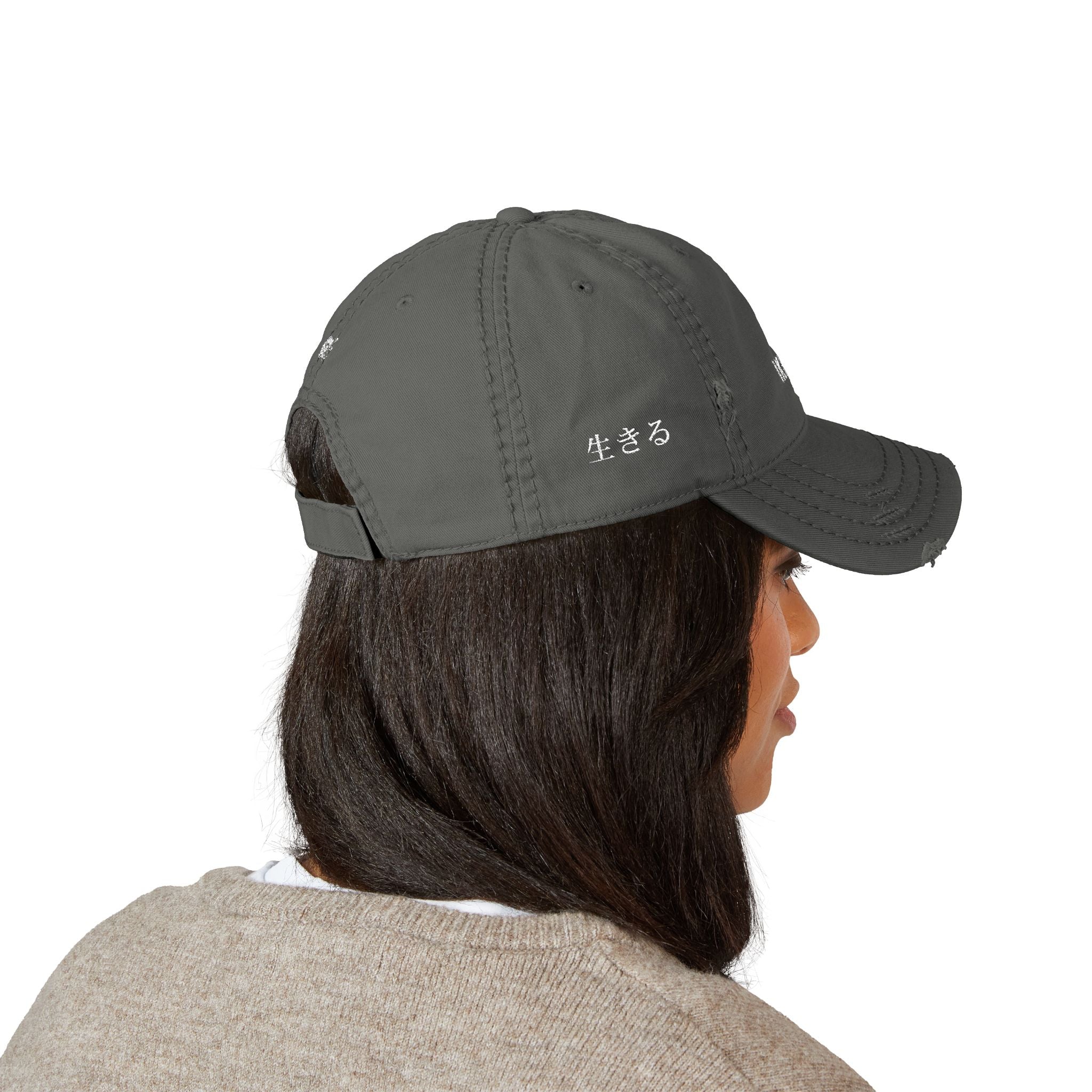 Person wearing a gray baseball cap on a white background