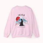Pink sweater with a mountain, samurai, and blossom tree design on the back saying 'un-influenceable' against a white background