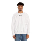 Person wearing a white sweatshirt a small ikiru logo on a white background