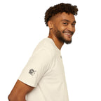 Man wearing a beige t-shirt with black text on a white background