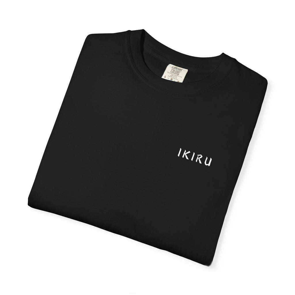 Folded black t-shirt with motivational quote and mountain graphic on a white background