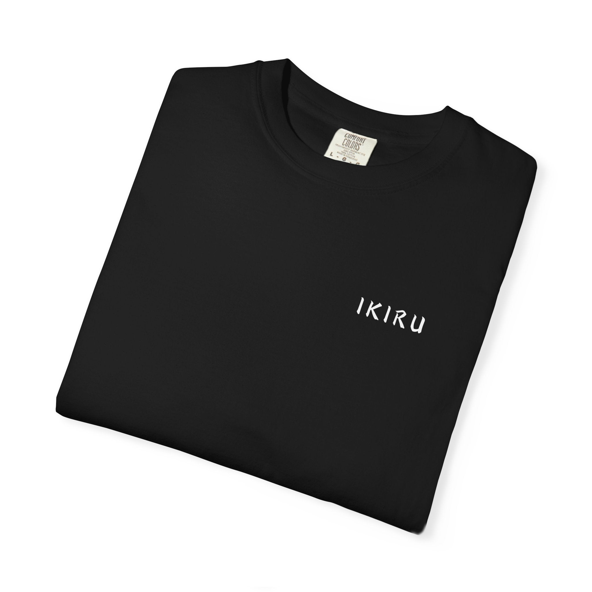 Folded black t-shirt with motivational quote and mountain graphic on a white background
