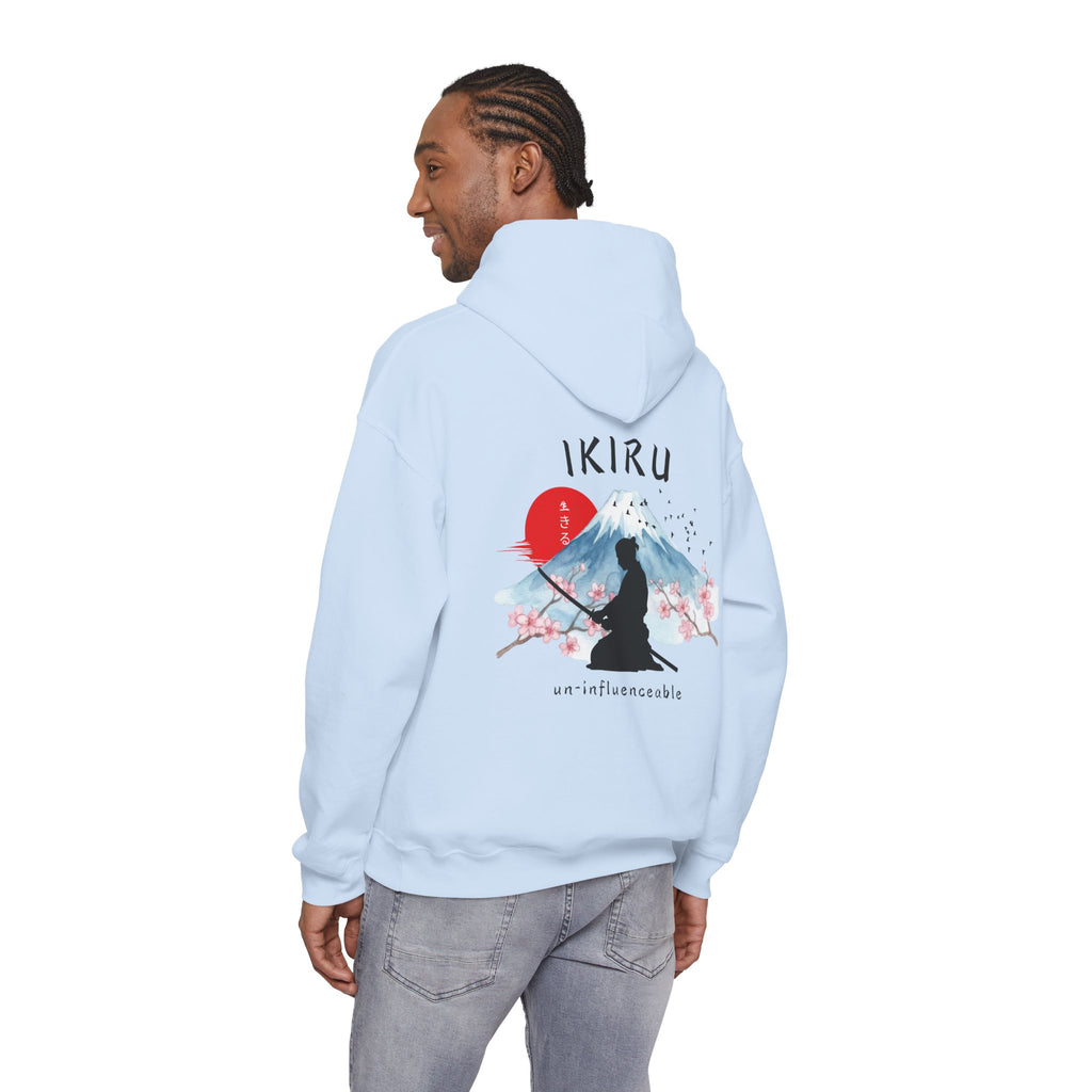 Light blue hoodie with 'IKIRU' and mountain, samurai, and blossom tree design on the back saying 'un-influenceable' against a white background