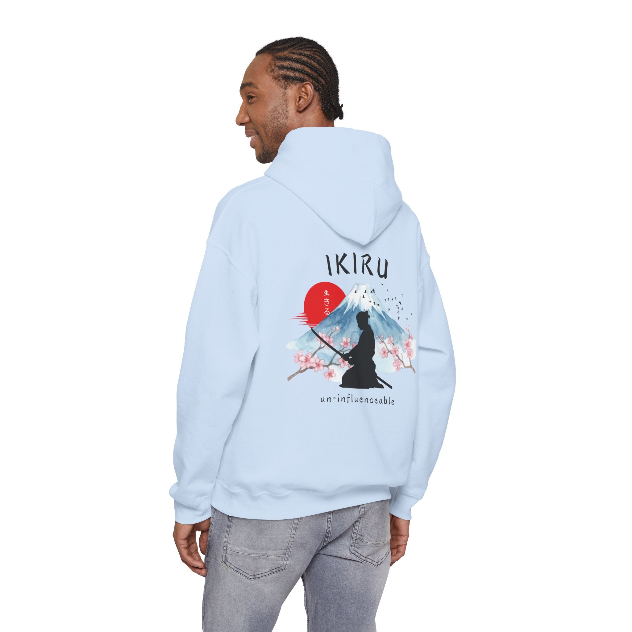Light blue hoodie with 'IKIRU' and mountain, samurai, and blossom tree design on the back saying 'un-influenceable' against a white background