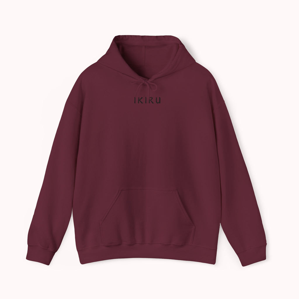 Maroon red hoodie with 'IKIRU' and mountain, samurai, and blossom tree design on the back saying 'un-influenceable' against a white background
