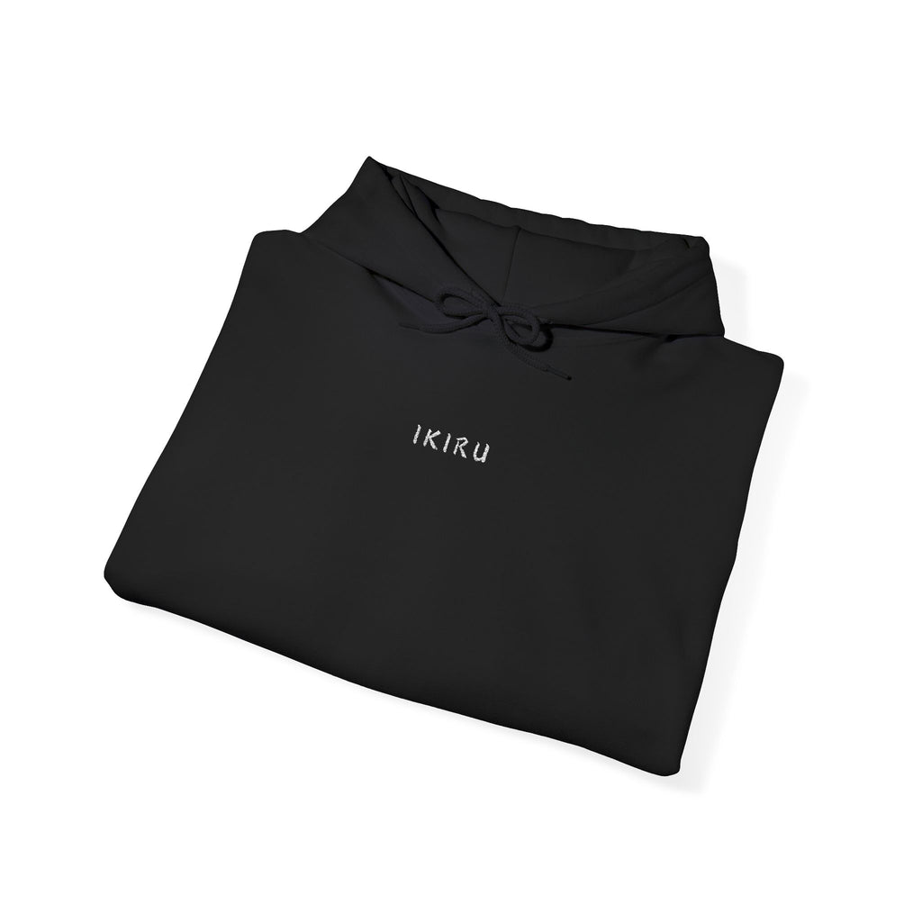 Folded black hoodie with 'IKIRU' text on a white background