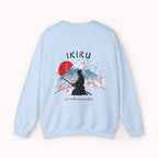 Light blue sweater with a mountain, samurai, and blossom tree design on the back saying 'un-influenceable' against a white background