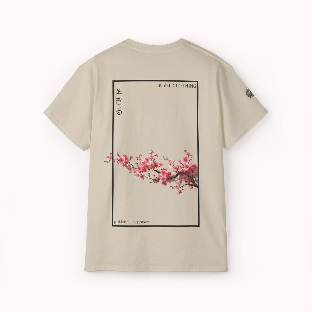 Beige t-shirt with cherry blossom design and 'IKIRU CLOTHING' branding on a white background