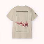 Beige t-shirt with cherry blossom design and 'IKIRU CLOTHING' branding on a white background
