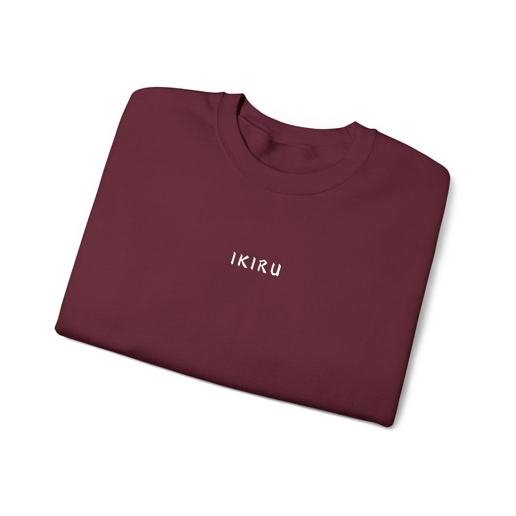 Folded Maroon sweatshirt with an IKIRU logo on a white background