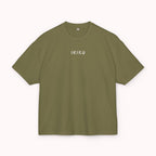 Green t-shirt with a small white logo on a white background