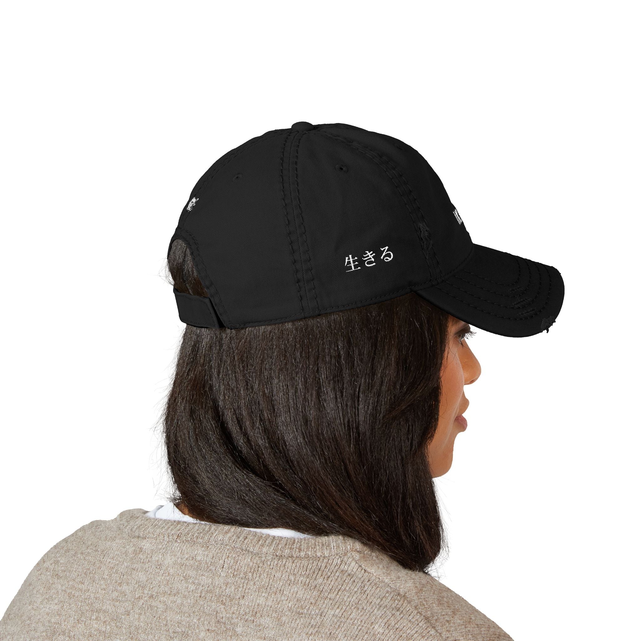 Person wearing a black cap with a logo on a white background
