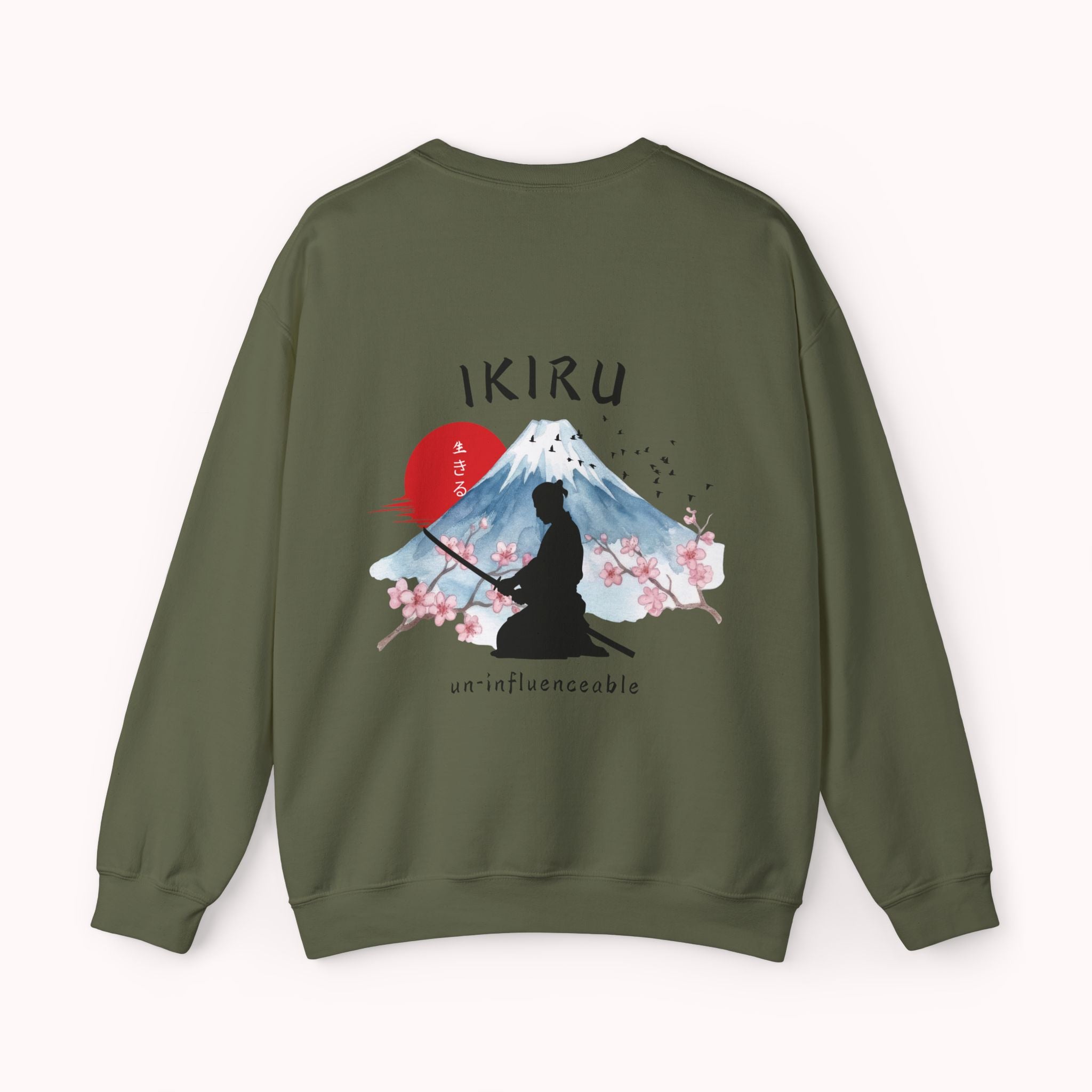 Green sweater with a mountain, samurai, and blossom tree design on the back saying 'un-influenceable' against a white background