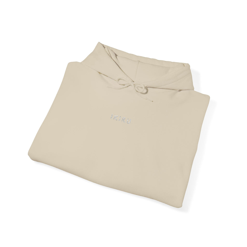 Folded beige hoodie with IKIRU logo on a white background