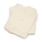 Folded sand shirt with an IKIRU logo on a white background