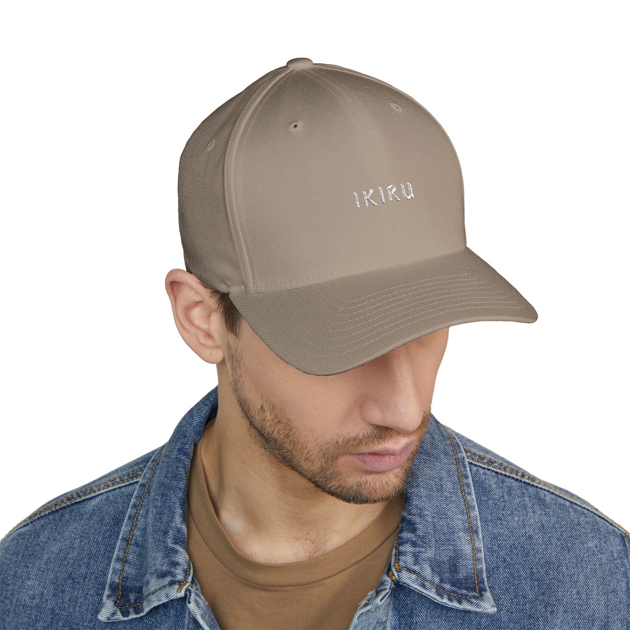 Person wearing a beige cap with IKIRU branding on a white background