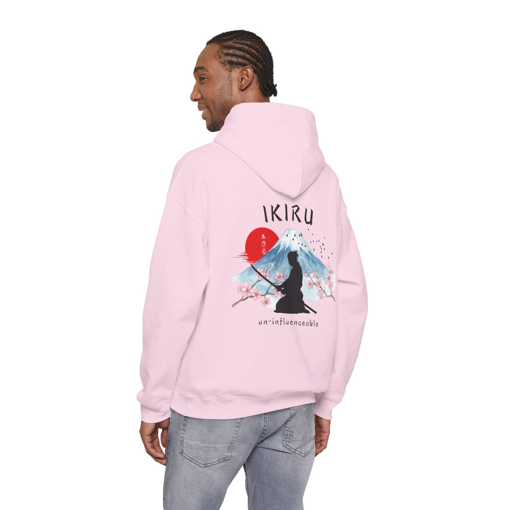 Light pink hoodie with 'IKIRU' and mountain, samurai, and blossom tree design on the back saying 'un-influenceable' against a white background