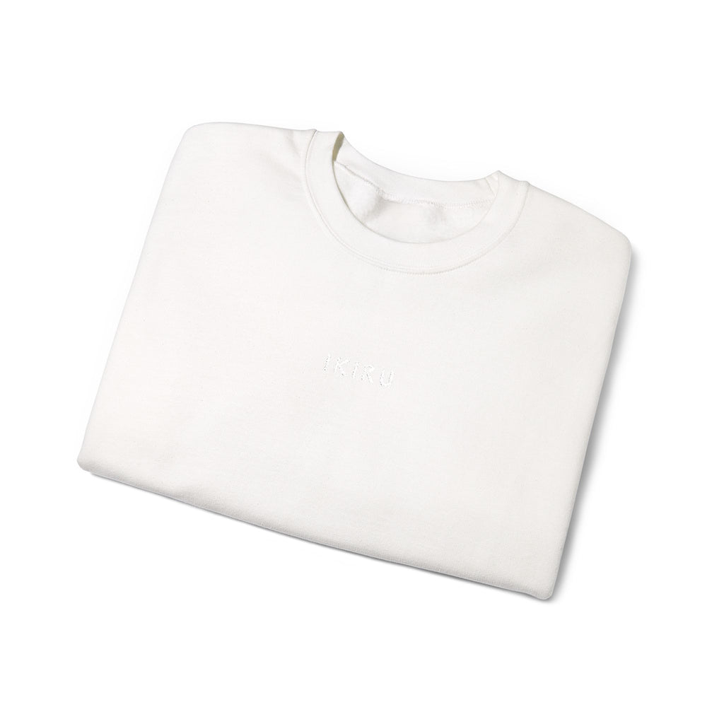 Folded white sweater with IKIRU logo on a white background