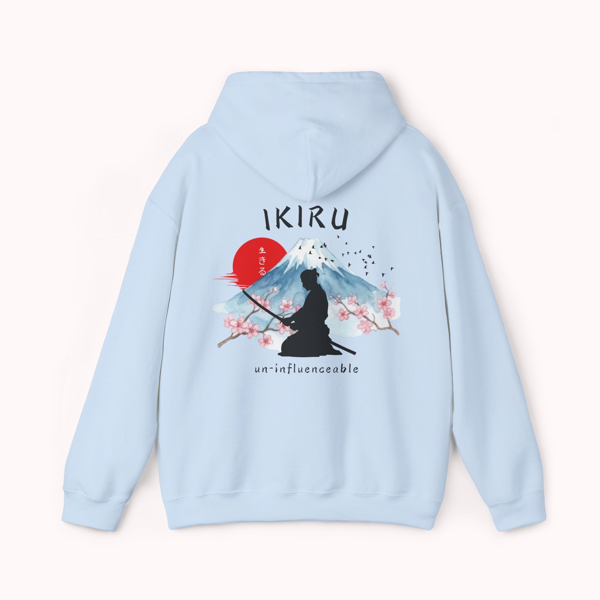 Light blue hoodie with 'IKIRU' and mountain, samurai, and blossom tree design on the back saying 'un-influenceable' against a white background