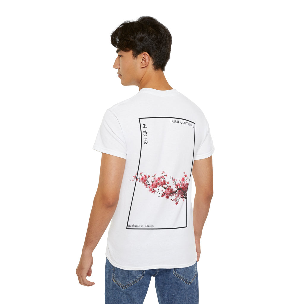 Person wearing a white shirt with a cherry blossom design and IKIRU text on a white background