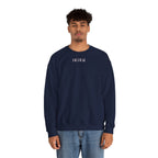 Man wearing navy sweater with a small ikiru logo on a white background
