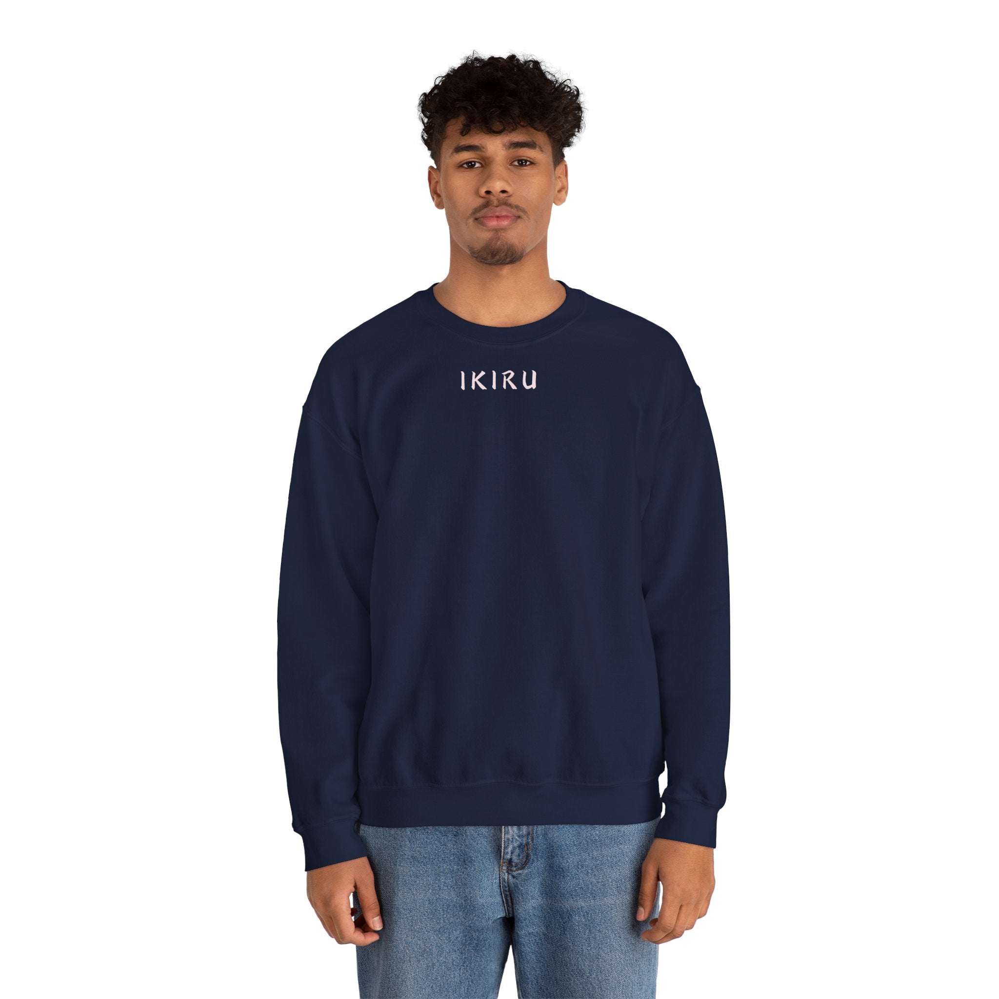 Man wearing navy sweater with a small ikiru logo on a white background