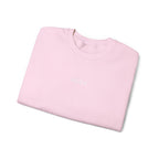 Folded pink sweater with IKIRU logo on a white background
