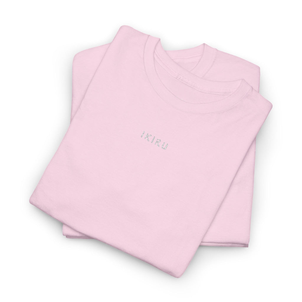 Folded pink shirts with 'IKIRU' embroidery on a white background