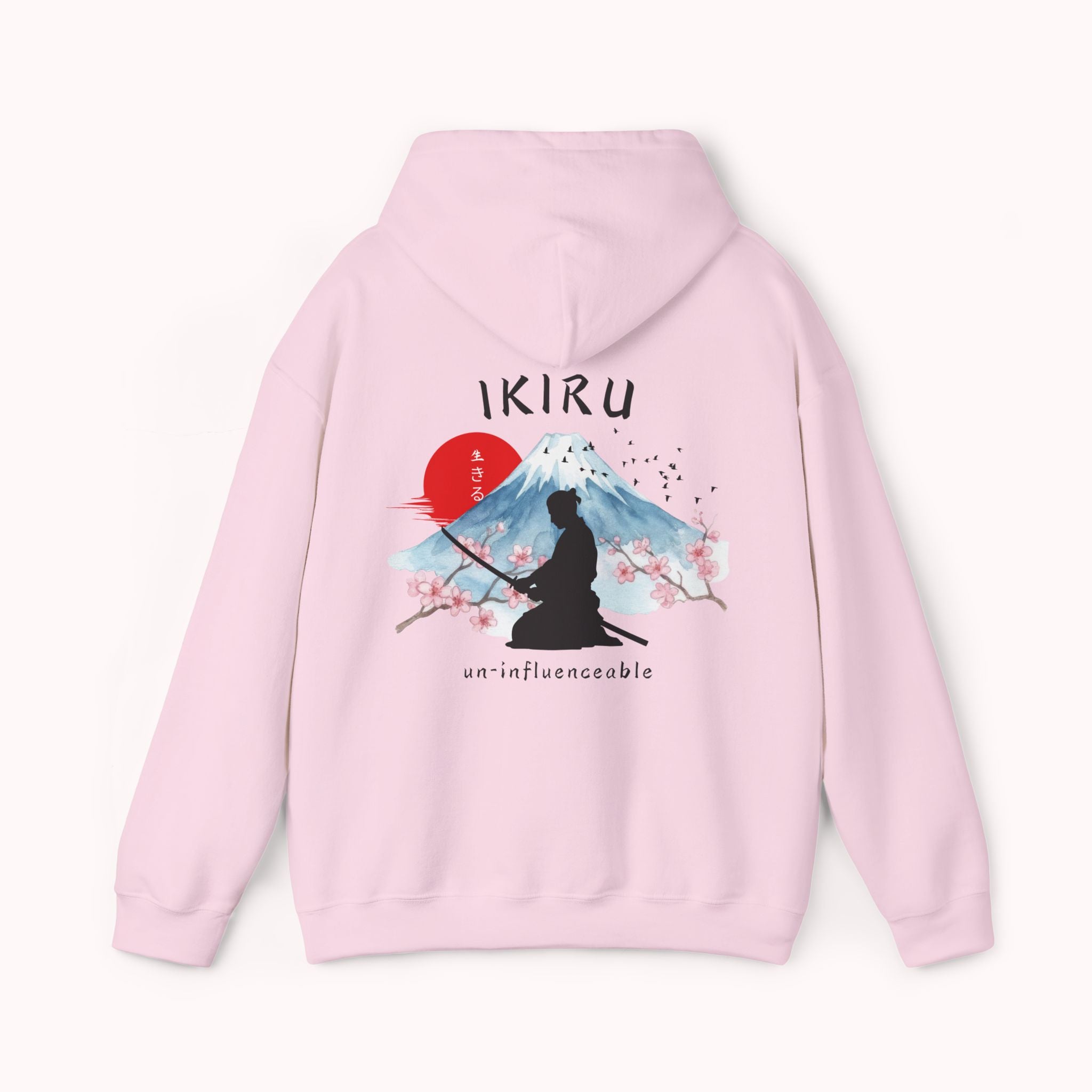 Light pink hoodie with 'IKIRU' and mountain, samurai, and blossom tree design on the back saying 'un-influenceable' against a white background