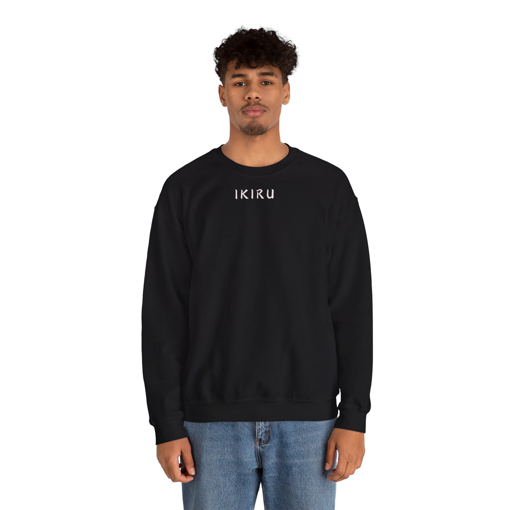 Man wearing black sweater with a small ikiru logo on a white background