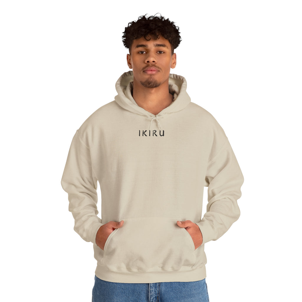 Beige hoodie with 'IKIRU' and mountain, samurai, and blossom tree design on the back saying 'un-influenceable' against a white background