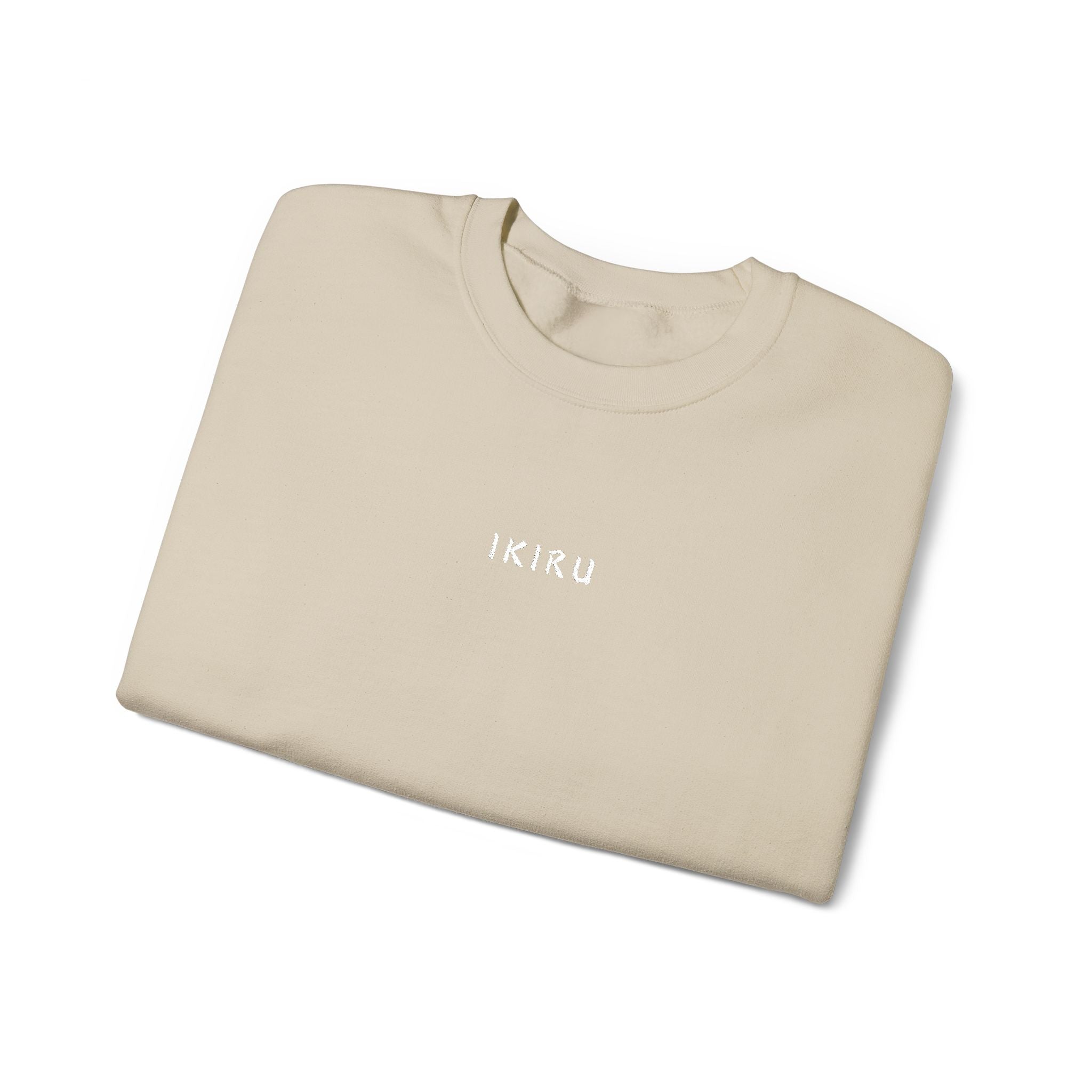 Folded beige sweater with IKIRU branding on a white background
