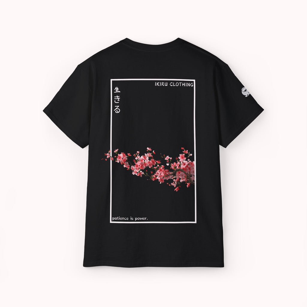Black t-shirt with cherry blossom design and 'IKIRU CLOTHING' branding on a white background