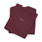 Folded maroon t-shirt with an IKIRU logo on a white background