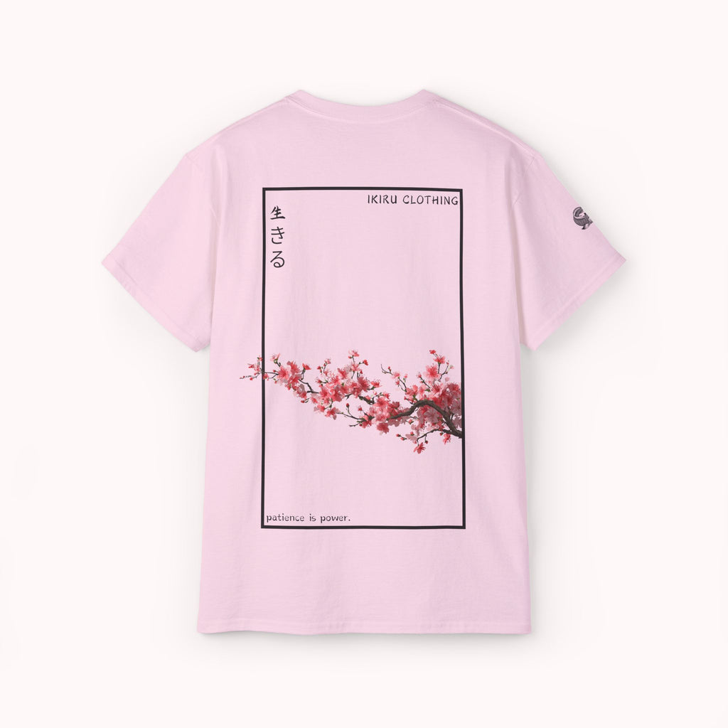 Pink t-shirt with cherry blossom design and IKIRU logo on a white background