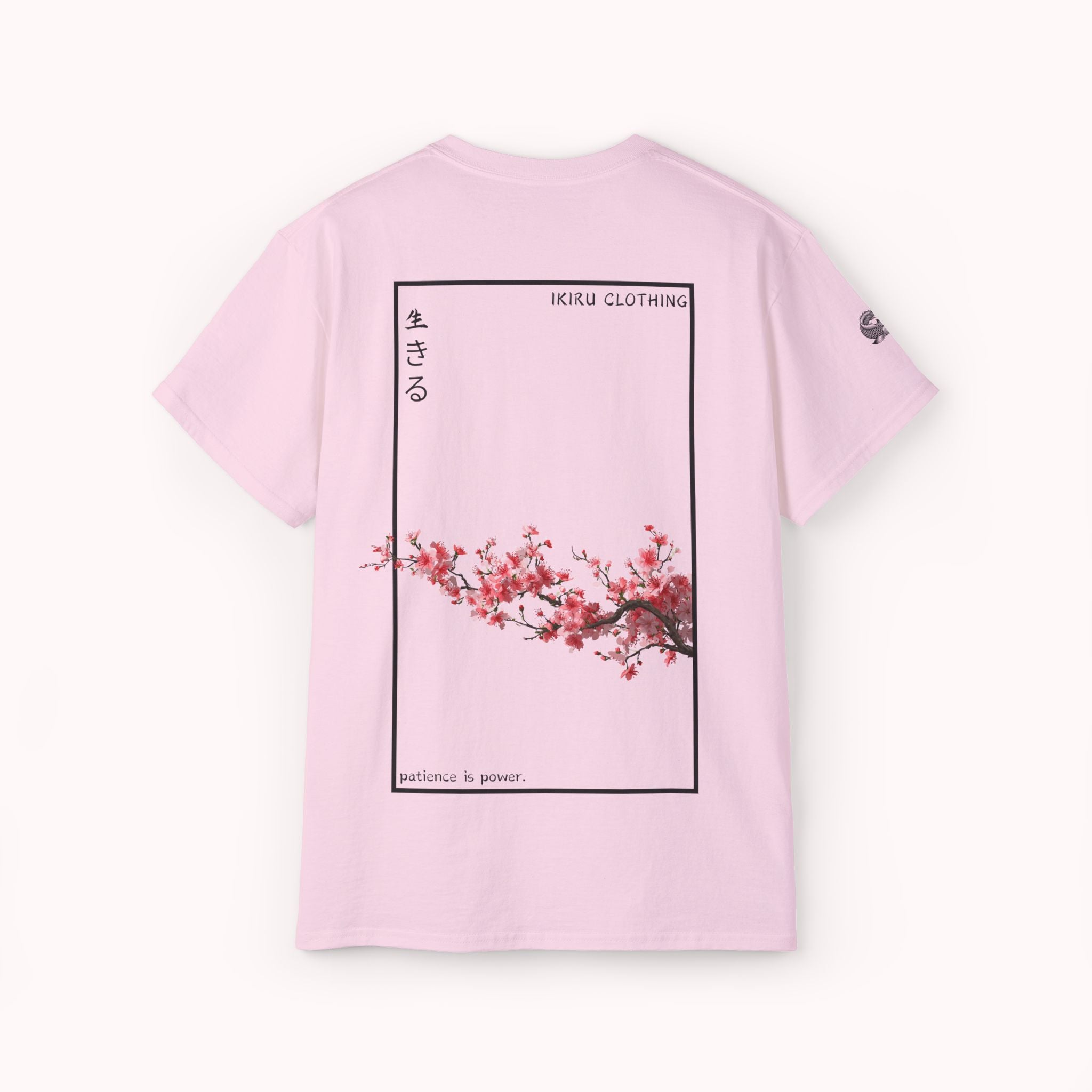 Pink t-shirt with cherry blossom design and IKIRU logo on a white background