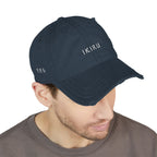 Navy blue cap with 'IKIRU' branding worn by a person on a white background