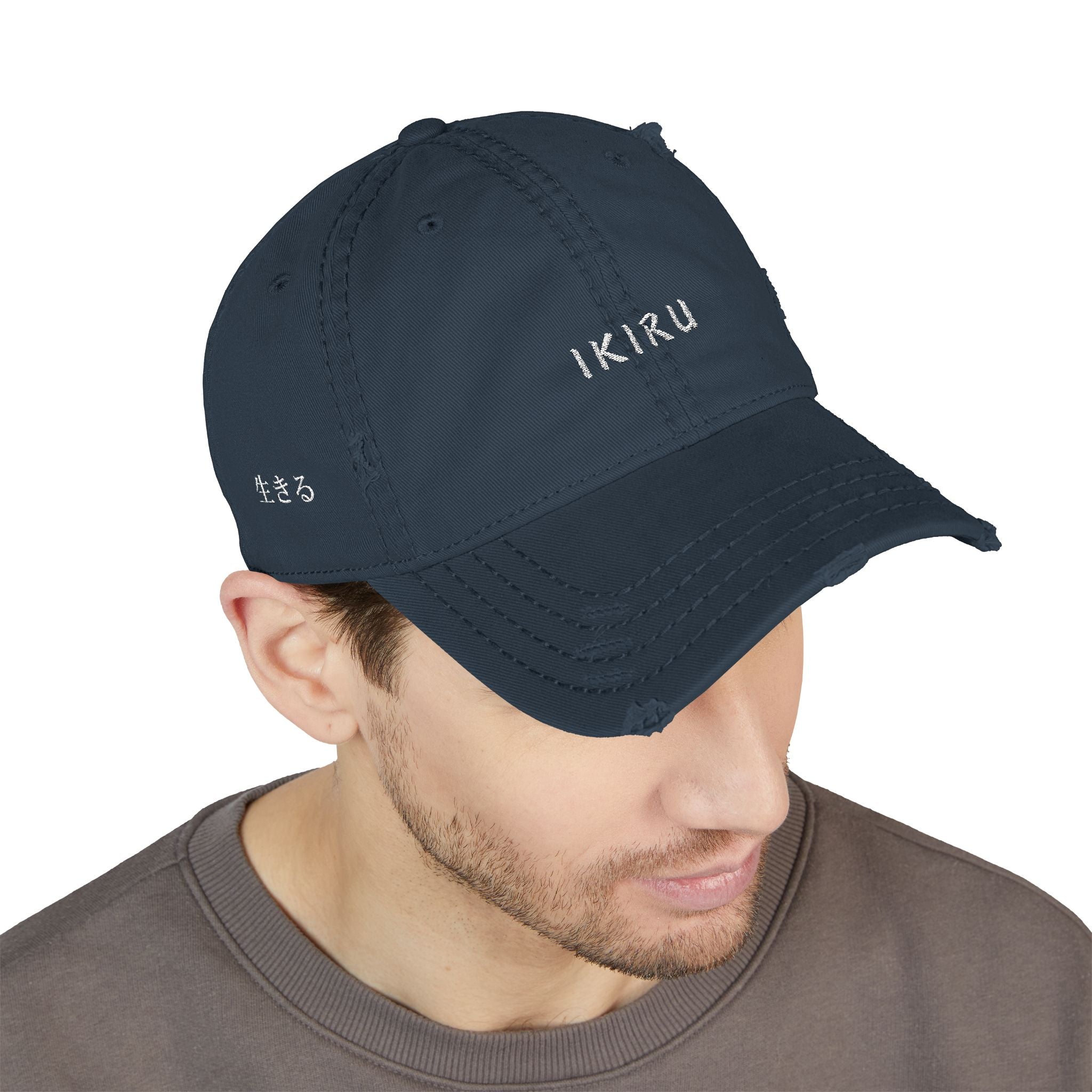 Navy blue cap with 'IKIRU' branding worn by a person on a white background