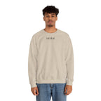Man wearing a beige sweatshirt with a small ikiru logo on a white background