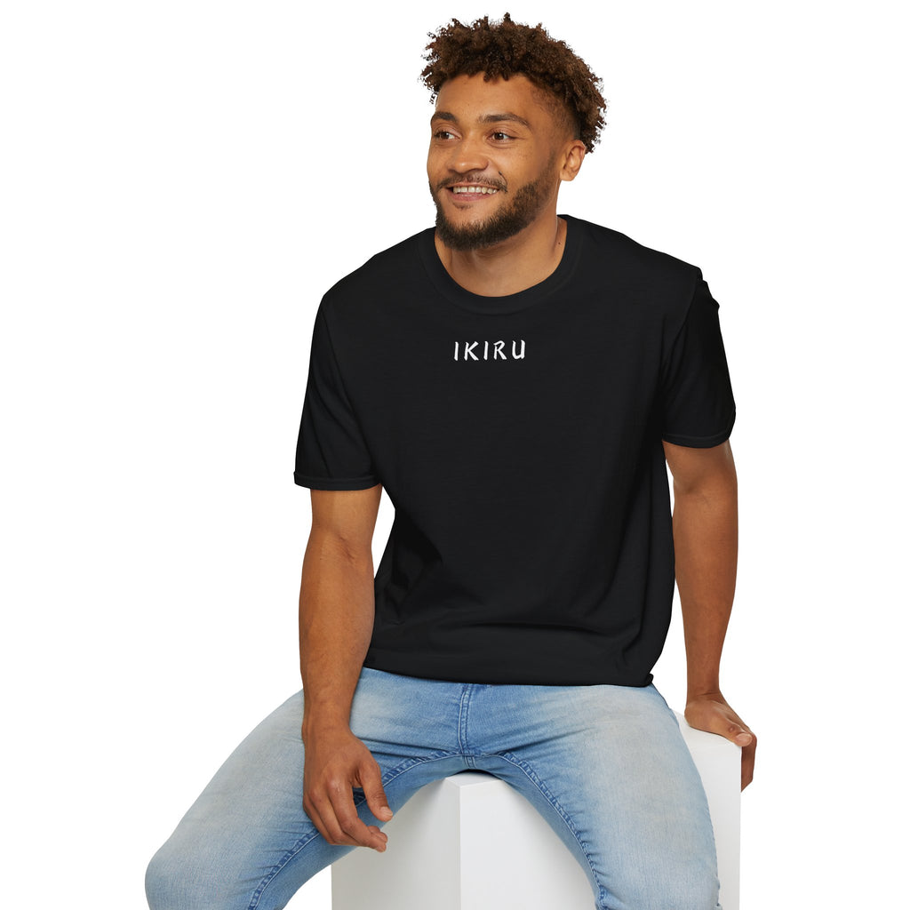 Man wearing a black t-shirt with text design, sitting on a white stool against a white background