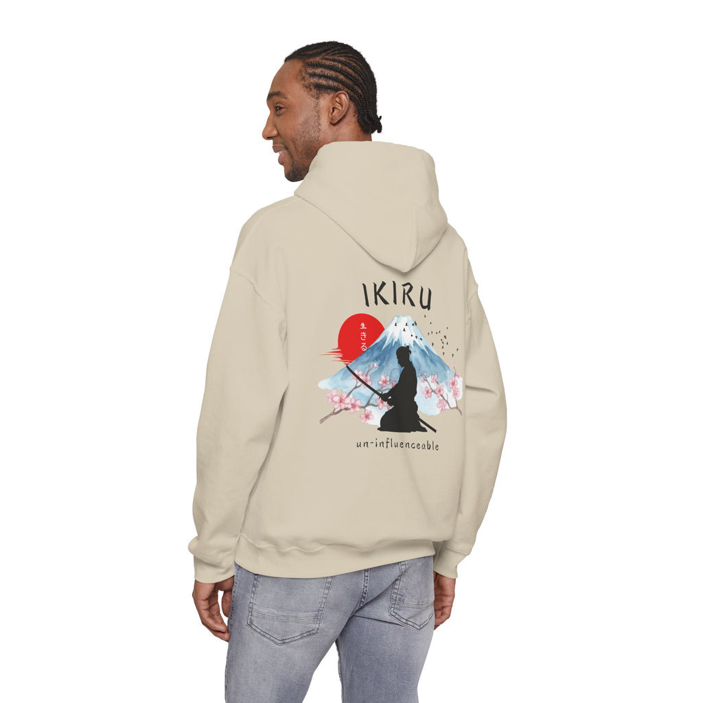 Beige hoodie with 'IKIRU' and mountain, samurai, and blossom tree design on the back saying 'un-influenceable' against a white background