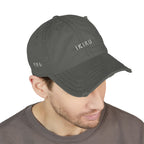 Man wearing a gray cap with a logo on a white background