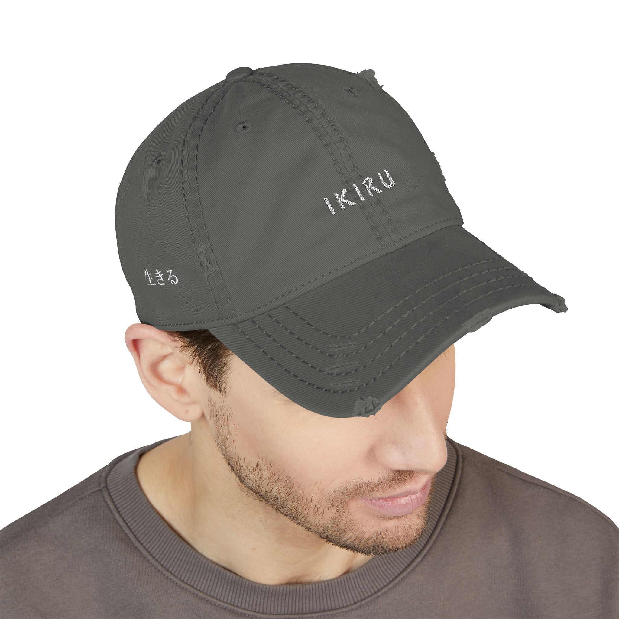 Man wearing a gray cap with a logo on a white background