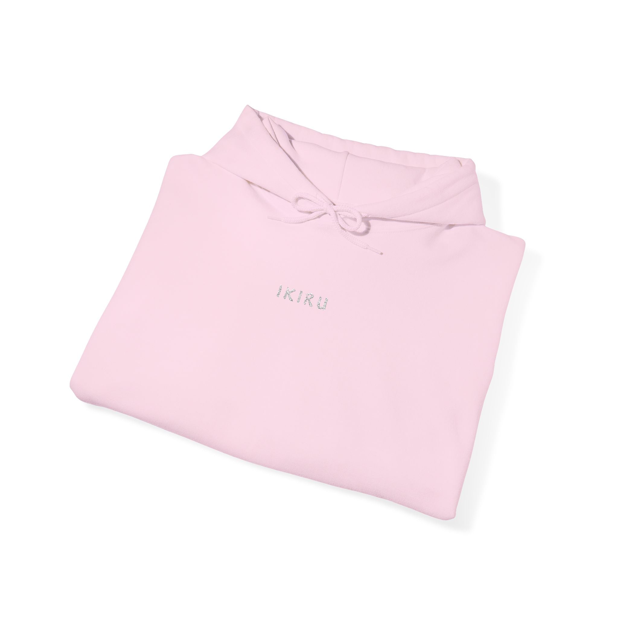 Folded pink hoodie with an IKIRU logo on a white background
